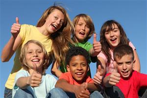 Six young teens, outside, with thumbs up