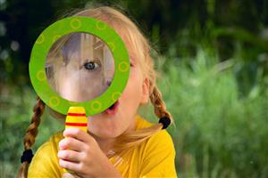 Girl with magnifying glass